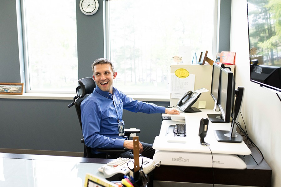 Man sitting at desk smiling