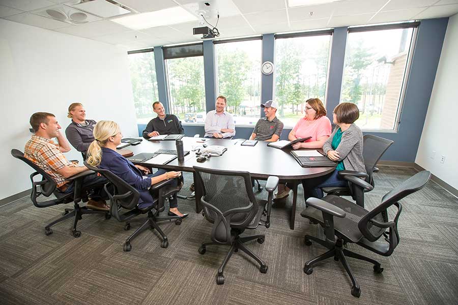 People sitting around table in meeting room