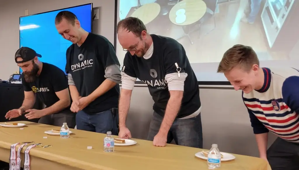 Dynamic Lifecycle Innovations team members participating in a work culture team building activity.|Dynamic Lifecycle Innovations team members participate in a holiday party work culture event.