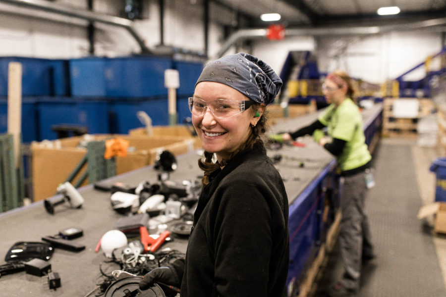 Smiling woman working on recycling line