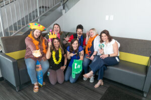 Team members at Dynamic Lifecycle Innovations pose with props.