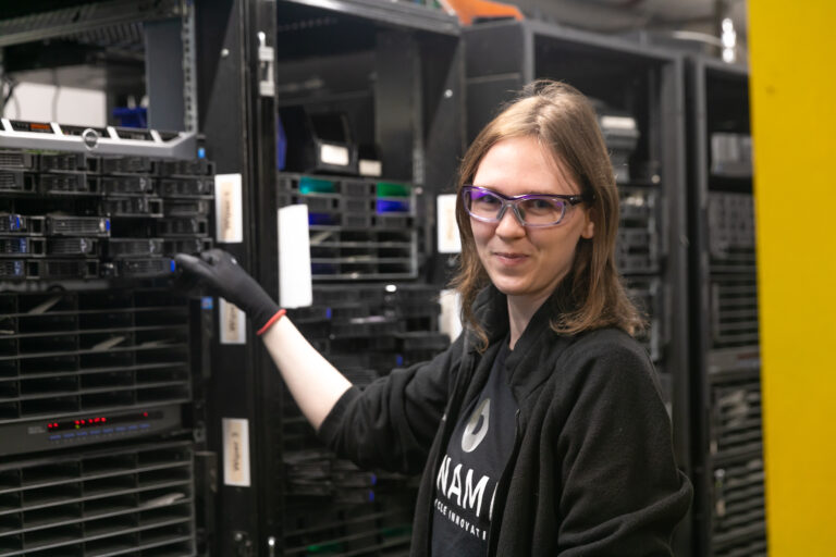 Dynamic Lifecycle Innovations employee sorting though electronics for recycling.