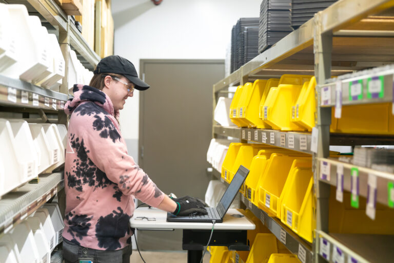 Dynamic Lifecycle Innovations employee in a sorting room for electronics recycling in Onalaska, Wisconsin.