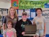 Anika Anderson & family proudly hold their new laptop they won from Dynamic Lifecycle Innovations at the Polk County event.