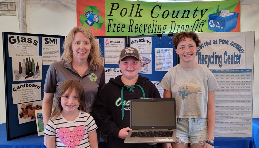 Anika Anderson & family proudly hold their new laptop they won from Dynamic Lifecycle Innovations at the Polk County event.