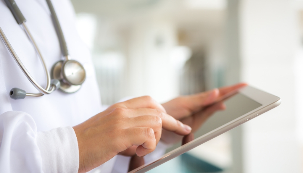 Doctor reviewing patient data on a tablet.