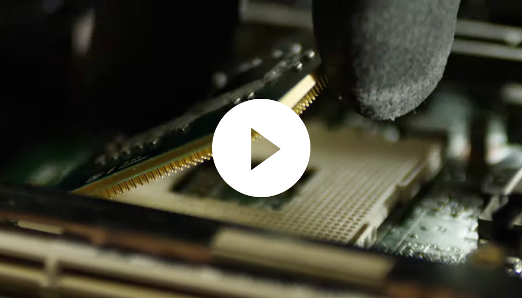 A person placing a computer chip on a motherboard.