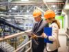 Business partners discussing an ITAD portfolio in an electronics recycling facility.