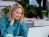 Woman taking a call on her laptop while working from home during the COVID-19 Pandemic.