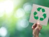 Person holding up the recycling symbol.