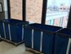 Blue e-recycling bins in the hallway of Western Technical College for a collection event.