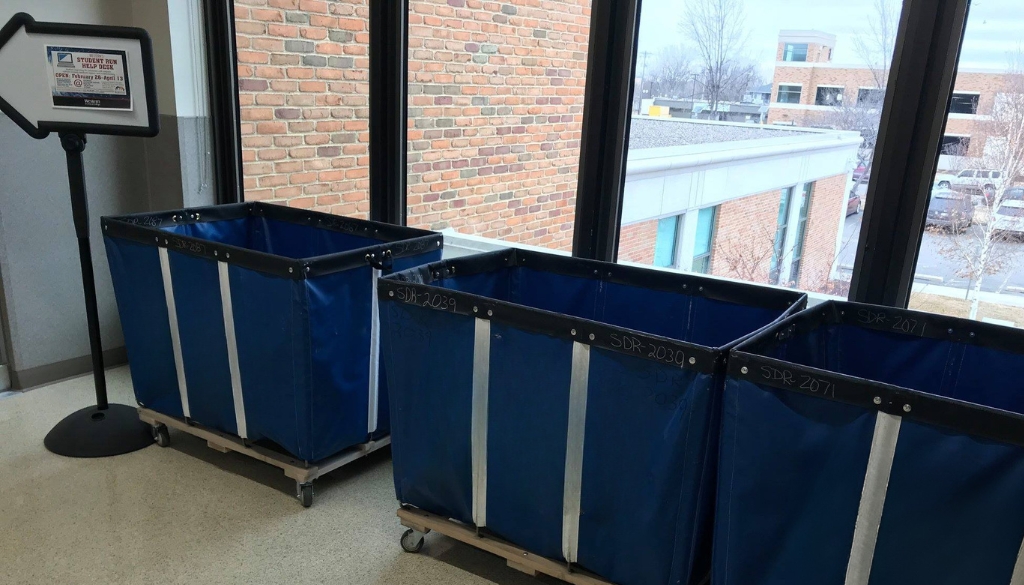 Blue e-recycling bins in the hallway of Western Technical College for a collection event.