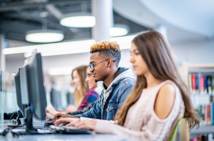 College students working in a computer lab of a library.