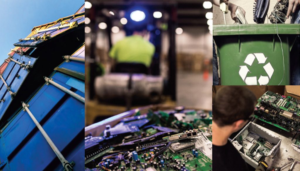 Electronics laying in piles by a recycling bin.