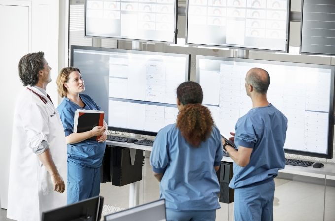 Healthcare workers discussing a treatment plan to schedule.